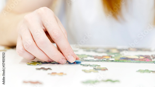 the girl collects puzzles in close-up