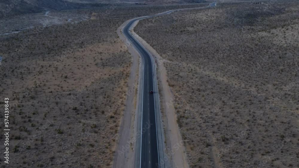 Overhead shot following a car to reveal the stunning, snow dotted red rocks of the Ruby Mountains at sunrise. This cinematic video was filmed near Las Vegas, Nevada using a DJI drone. Overhead shot following a car to reveal the stunning, snow dotted red rocks of the Ruby Mountains at sunrise. This cinematic video was filmed near Las Vegas, Nevada using a DJI drone.