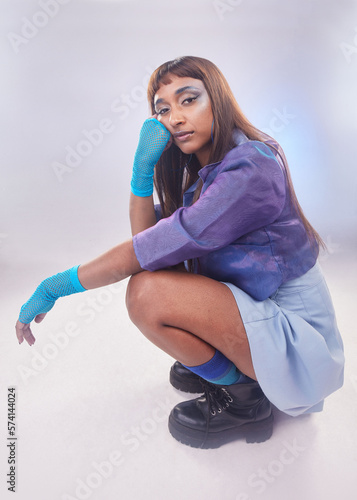 Portrait, fashion or makeup with an edgy black woman in studio on a neon background for trendy style. Rock, creative and cosmetics with an attractive young female model posing in contemporary clothes
