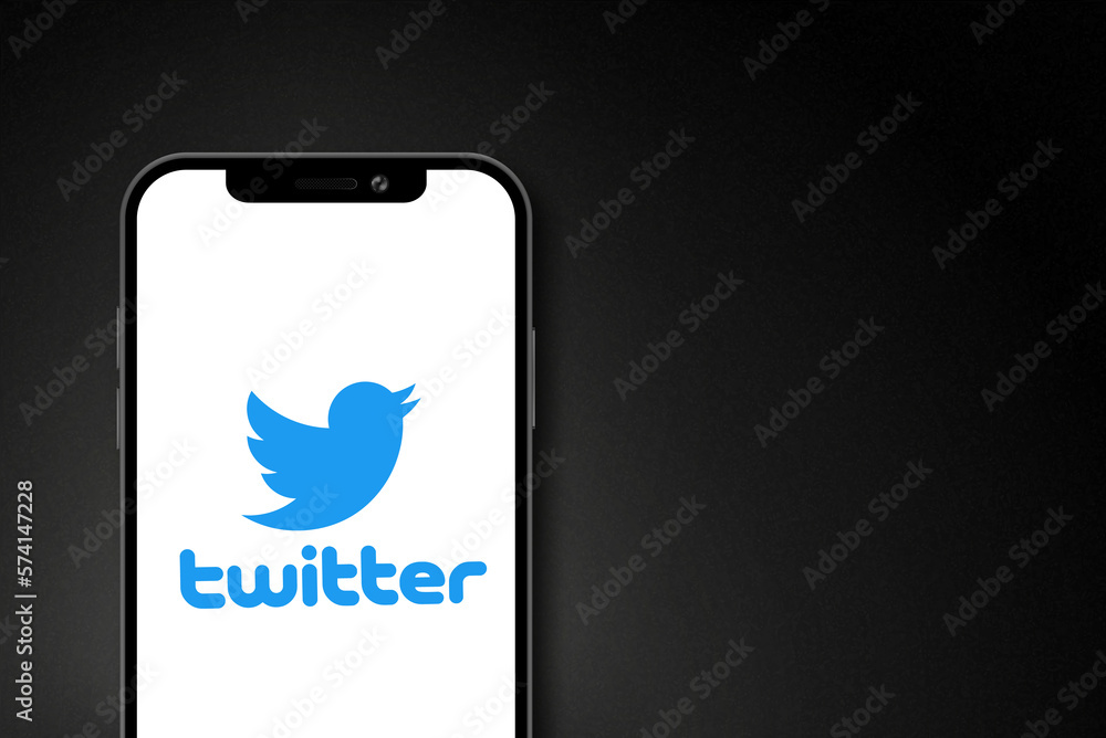 Twitter logo on smartphone screen on black background. Twitter is a