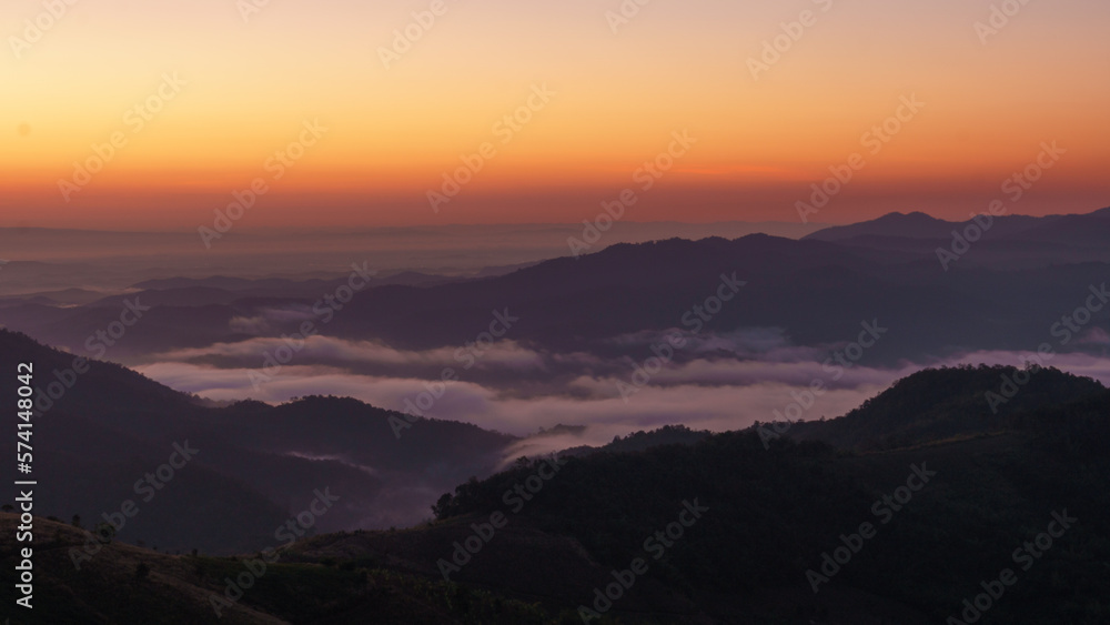 sunrise over a mountain sea of fog Doi chang chiangrai Thailand