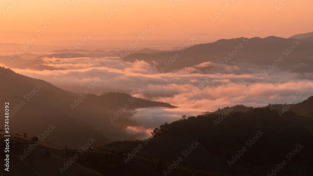 sunrise over a mountain sea of fog Doi chang chiangrai Thailand