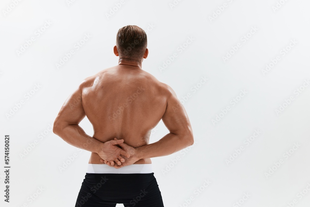 Man athletic body bodybuilder in briefs with naked torso abs full-length in the background, fitness classes. Advertising, sports, active lifestyle, competition, challenge concept.