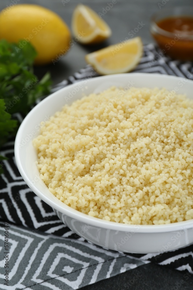 Bowl of tasty couscous on grey table, closeup Bowl of tasty couscous on grey table, closeup