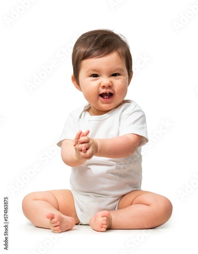 Cute baby in white onesie on white background