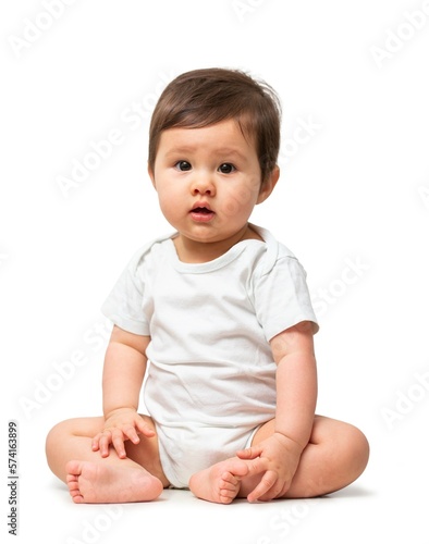 Cute baby in white onesie on white background