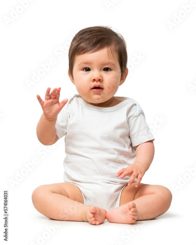 Cute baby in white onesie on white background