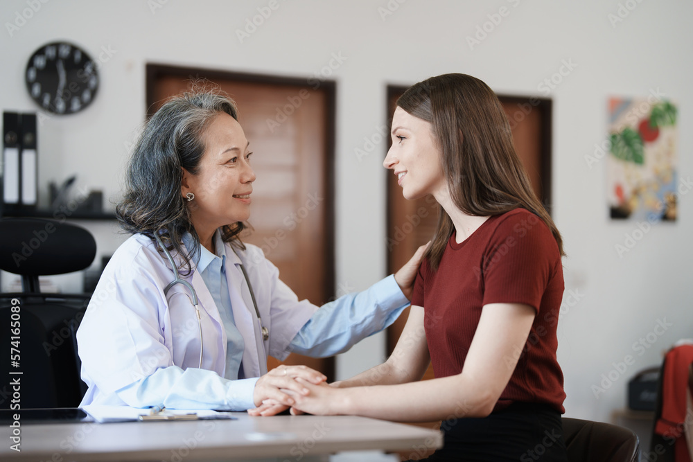 Portrait of a female doctor holding a patient's hand to encourage the fight against disease. Portrait of a female doctor holding a patient's hand to encourage the fight against disease.