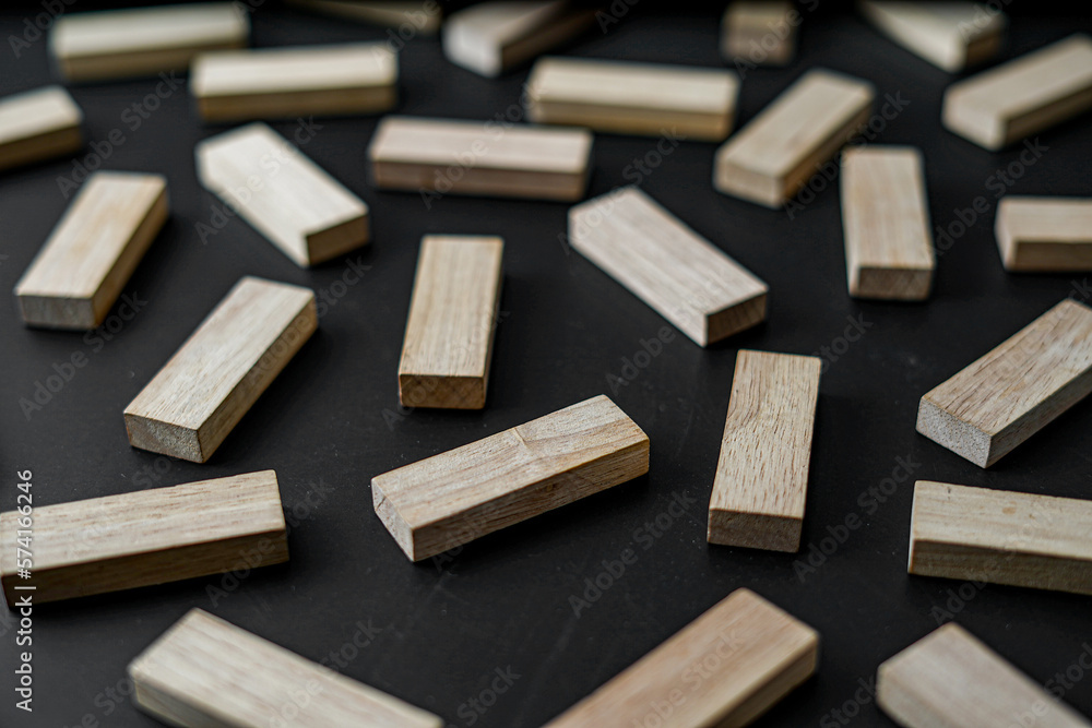 wooden blocks on a dark background, text to write. Jenga blocks. wooden blocks on a dark background, text to write. Jenga blocks.