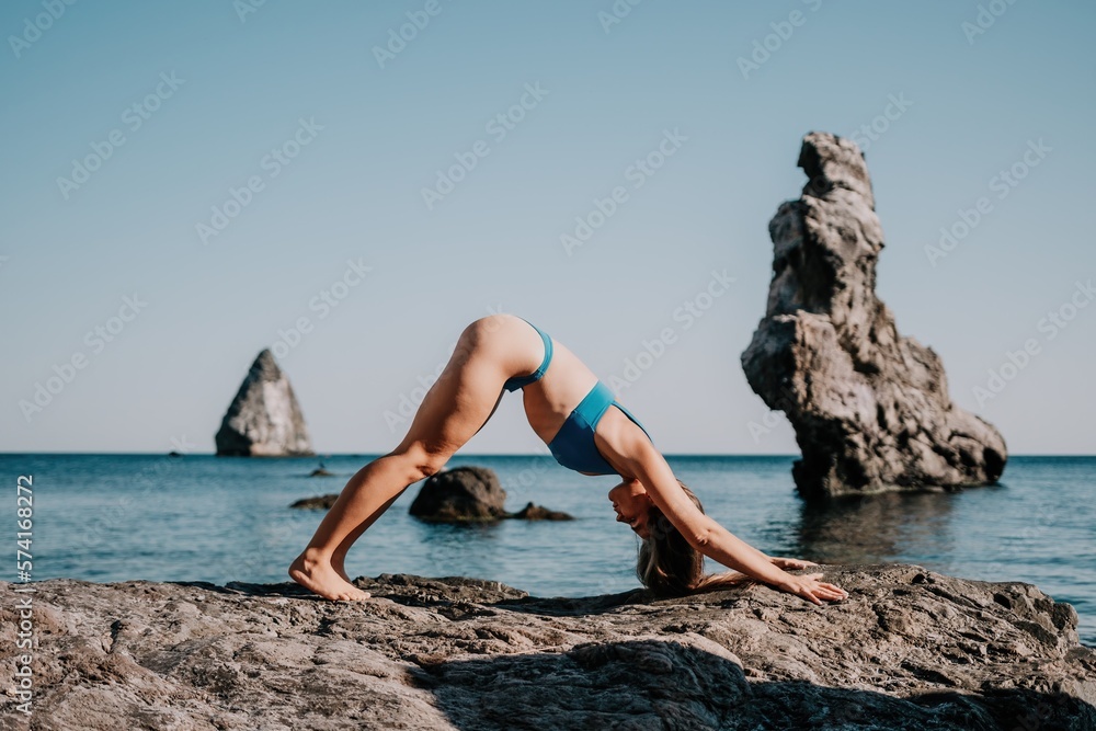 Woman sea pilates. Sporty happy middle aged woman practicing fitness on beach near sea, smiling active female training on yoga mat outside, enjoying healthy lifestyle, harmony and meditation.