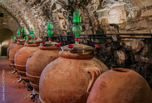 Chianti wine from Sangiovese grapes aging in terracotta clay amphora at a vineyard cellar in the famous Chianti Classico wine region of Tuscany, Italy photo