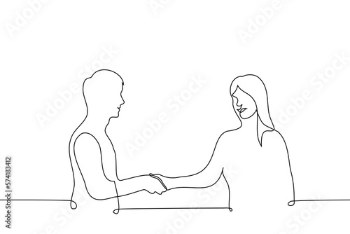 man and woman shaking hands, they are smiling at each other - one line drawing vector. the concept of a pleasant meeting or acquaintance of a man and a woman