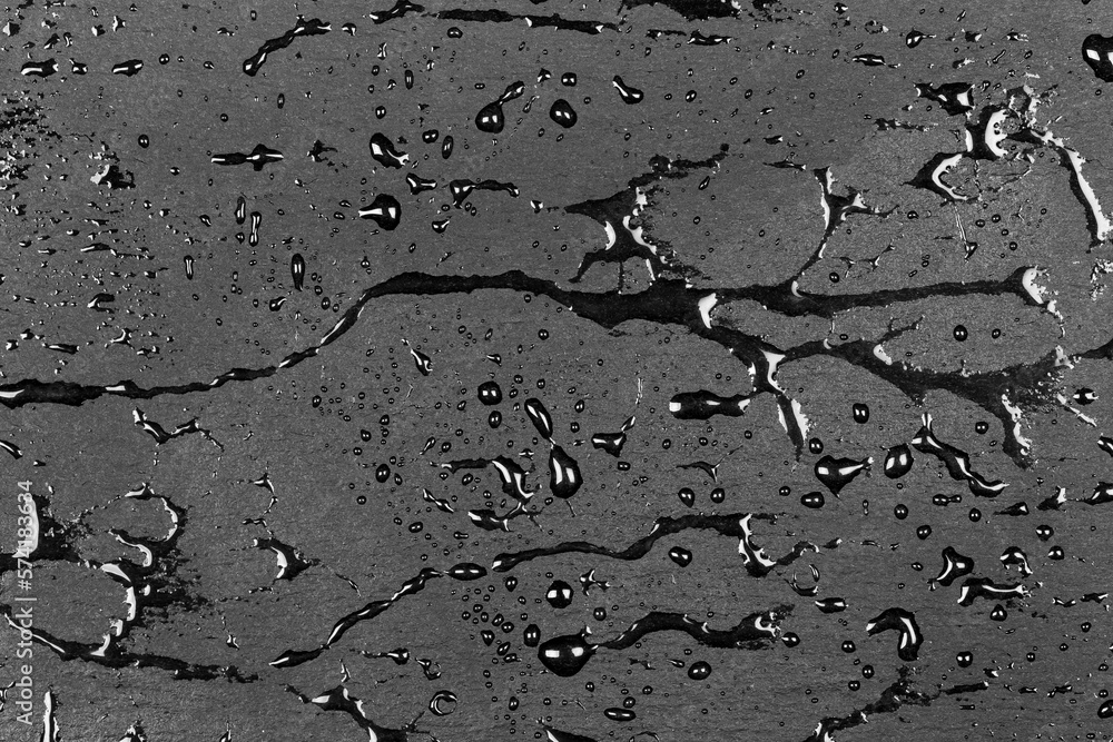 Water on dark flat stone surface Water on dark flat stone surface