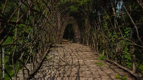 Inside Mauri natural bridge, Ponte San Vigilio, made with branches, dolly out photo