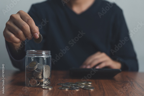 Man holding a coin jar.investment financial and banking, savings money, buying insurance, retirement money.business finance management concept.