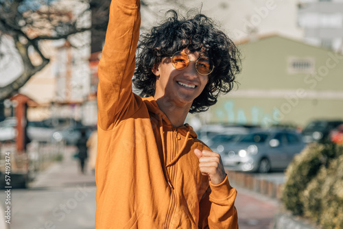 latin cuban boy with arms raised in victory gesture