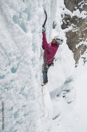 A woman ice climbing on Senator Falls near Ouray, Colorado. photo