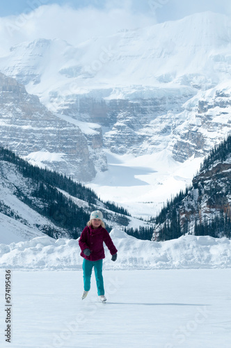 A young girl ice skating on Lake Louise in, Banff National Park,  Lake Louise, Alberta, Canada. photo