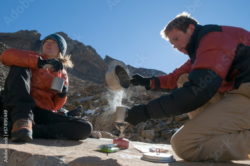 A man and a woman boiling water on a campstove above treeline near Telluride, Colorado.