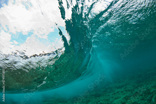 A wave is seen breaking from underwater on a section of Glover's Reef, Belize. photo