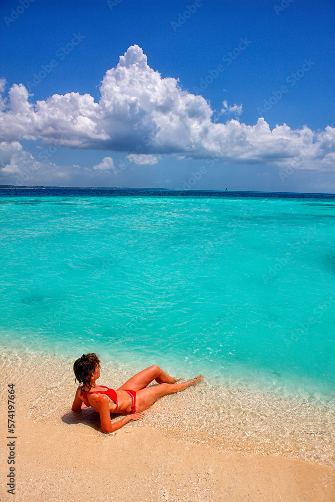 Tanzania, Zanzibar, Unguja, Niamembe Island. Woman sunbathing Tanzania, Zanzibar, Unguja, Niamembe Island. Woman sunbathing