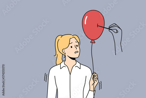 фотографія Huge hand pierce balloon with needle