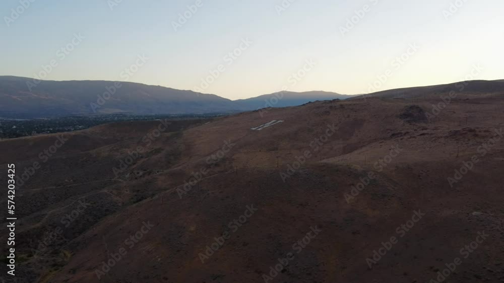 Aerial shot of the Nevada N on a desert hill overlooking Reno, Nevada. This beautiful shot was filmed at sunset using a DJI drone. Aerial shot of the Nevada N on a desert hill overlooking Reno, Nevada. This beautiful shot was filmed at sunset using a DJI drone.