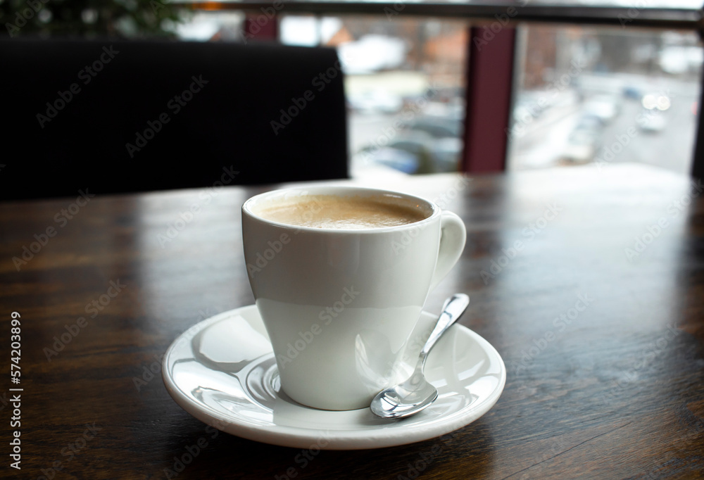 Close up white cup of coffee latte on wood table in cafe Close up white cup of coffee latte on wood table in cafe