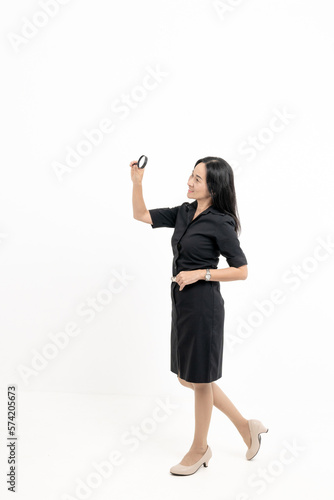 Accountant gestures for a magnifying glass to shine Business accounting audit concept isolated through white background