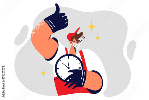 Worker in medical mask holds clock and shows thumbs up approve imposition of lockdown or quarantine