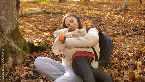Happy mom hugs a teenage girl found lost in the autumn forest