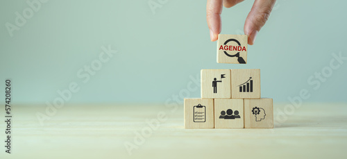 Agenda meeting appointment activity information concept. List of meeting activities in the order to be taken up, beginning with the call to order, ending with adjournment. Wooden cubes background. photo