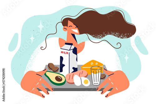 Satisfied woman with natural fresh food on tray preparing for hearty high-calorie breakfast 