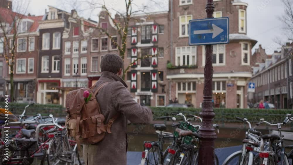 Hipster tourist capturing Amsterdam's canal essence. Netherlands travel Hipster tourist capturing Amsterdam's canal essence. Netherlands travel