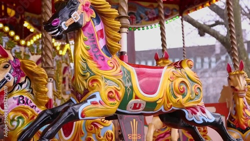 Colorful horses in motion, in a carousel on Queen's Walk in London