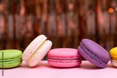 Sweet colorful macarons  on pink background. Tasty colourful macaroons. High quality photo