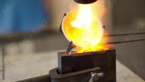 Macro of a goldsmith heating the steel to make a ring. Concept: silver, style, production. High quality 4k footage