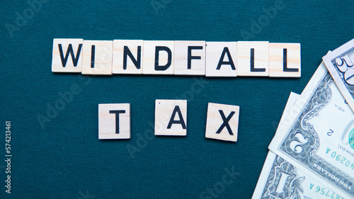 inscription windfall tax next to US dollars. Concept of windfall tax 