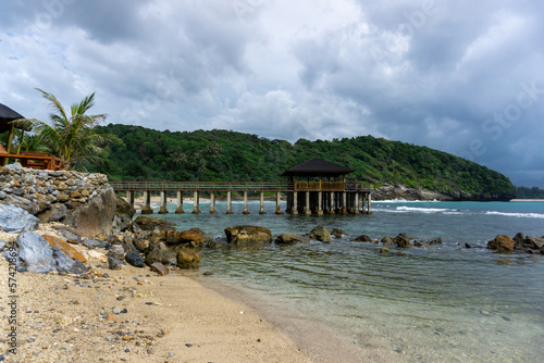  tropical beach in Banda Aceh  Indonesia. Eky Momong Beach. Resataurant at the beach. Concrete bridge leading to water villa or bungalow.