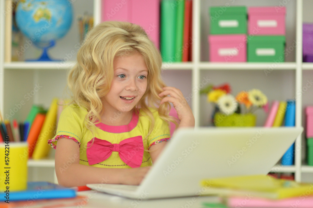 girl using laptop at desk at home girl using laptop at desk at home