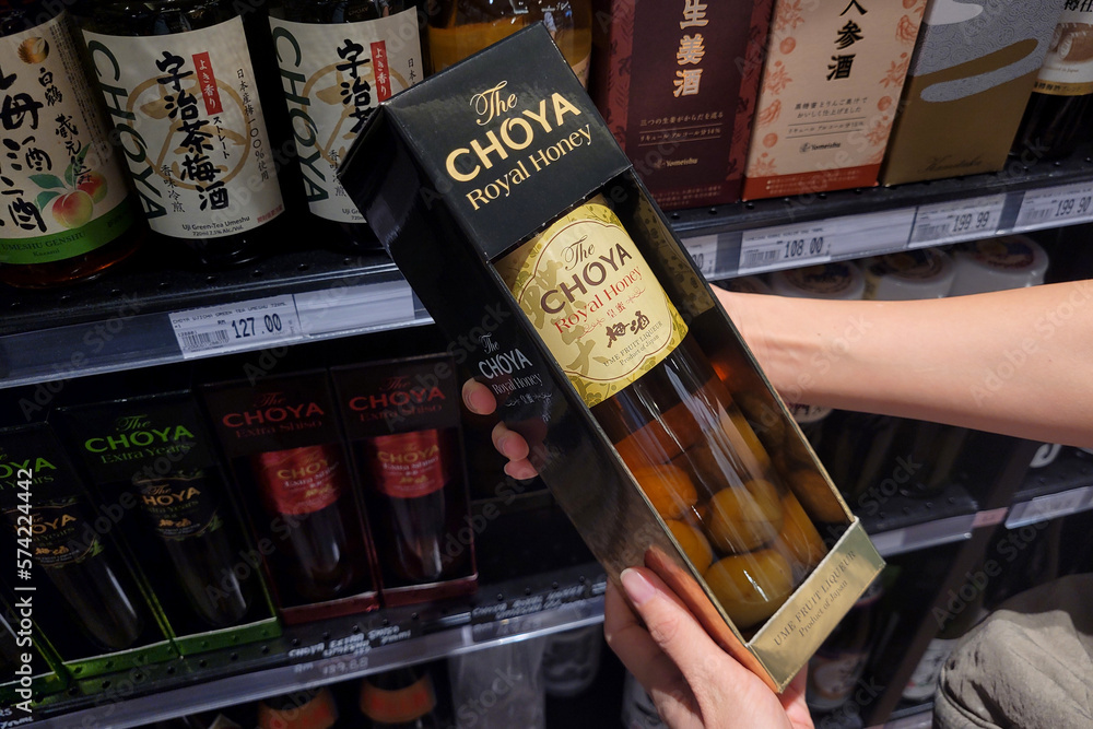PENANG MALAYSIA 22 FEB 2023 Adult Hands Holding A Bottle Of Choya penang-malaysia-22-feb-2023-adult-hands-holding-a-bottle-of-choya