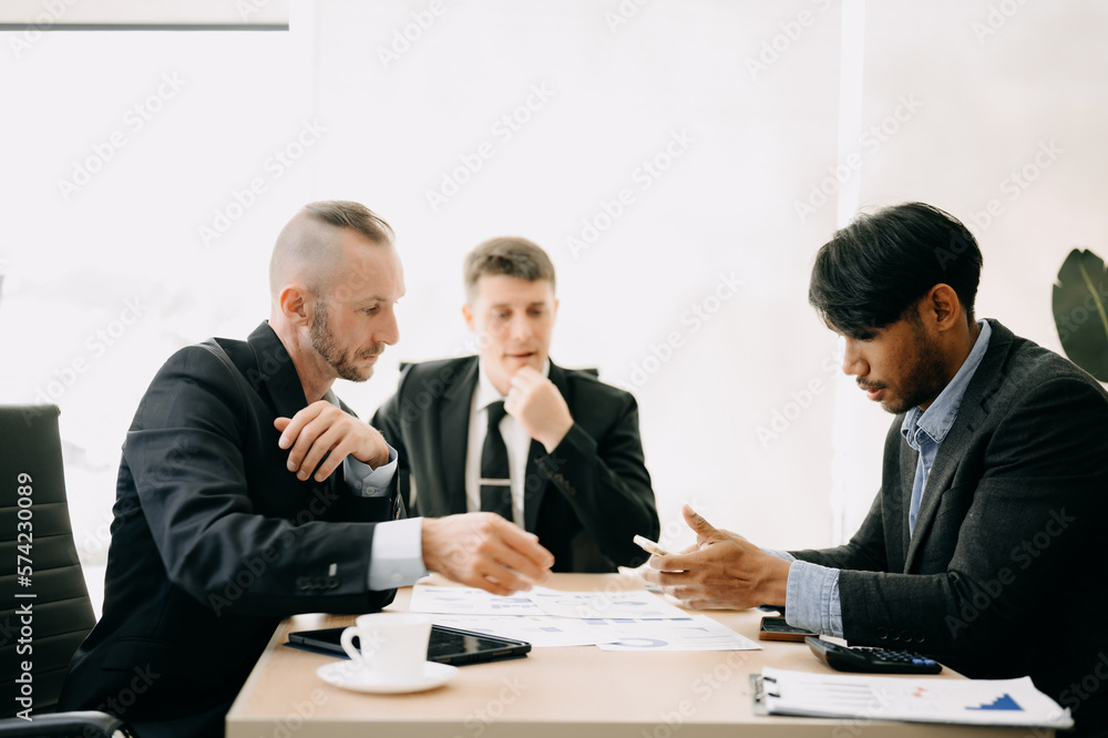 Fototapeta premium Business team discuss at meeting room. working together with laptop ,tablet and smart phone on desk Financial accountant , planner , meeting , introduction concept. At office.