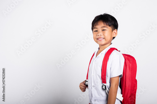 Asian adorable toddler smiling happy wearing student thai uniform standing in studio shot isolated on white background, Portrait little children boy preschool, Happy child Back to school