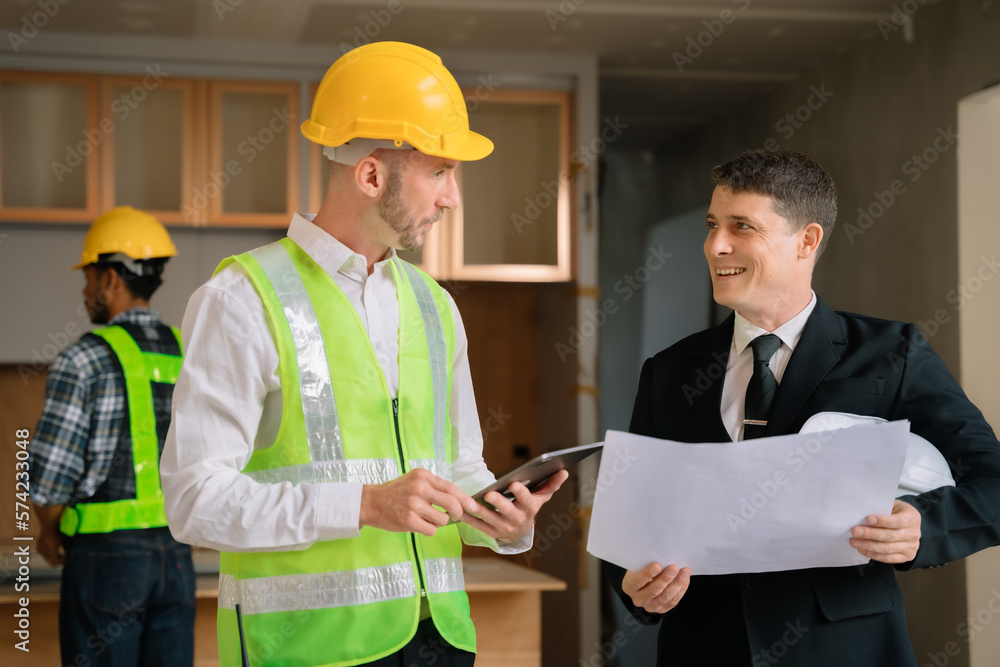 Group architect team on construction site inspection documents and business workflow in the morning. Group architect team on construction site inspection documents and business workflow in the morning.
