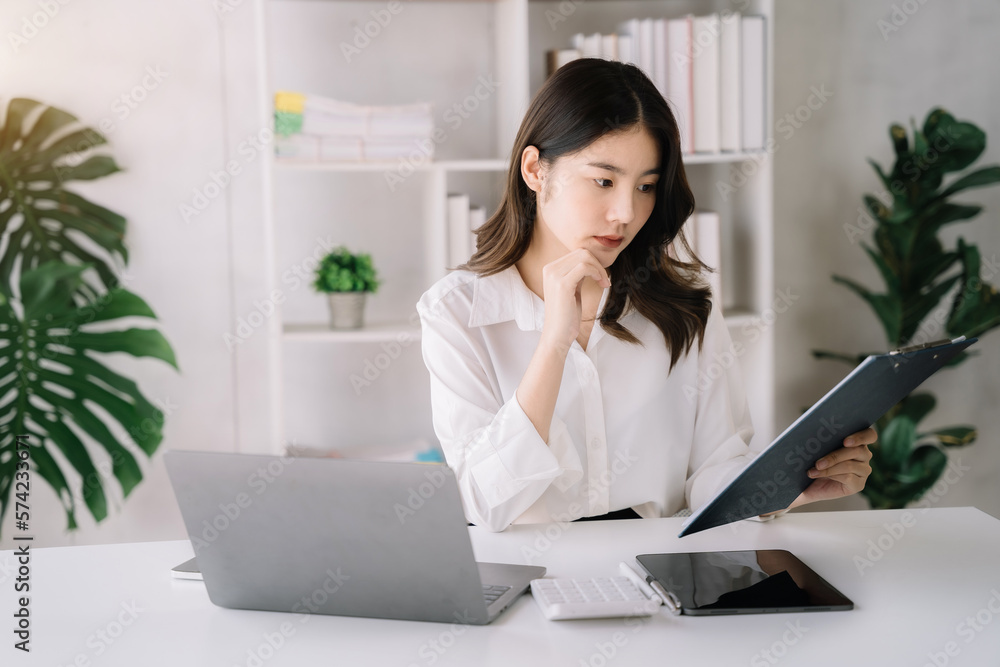 Business woman working at office with laptop and documents on his desk, financial adviser analyzing data. Business woman working at office with laptop and documents on his desk, financial adviser analyzing data.