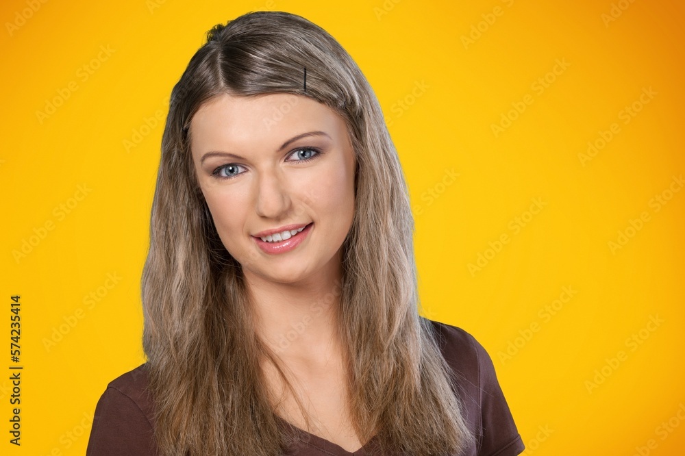 Smiling young woman posing on background
