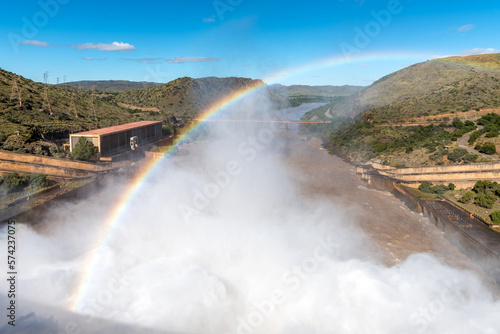 The Gariep Dam overflowing. A rainbow is visible