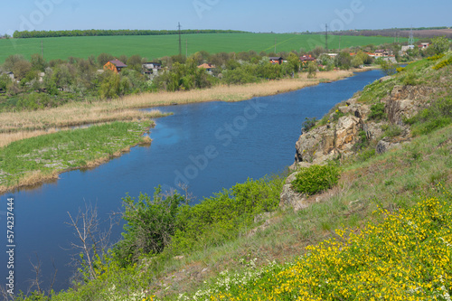 Early spring landscape with rocky Sura riverside and summer cottages near Dnipro city, Ukraine