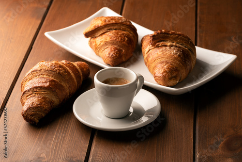 Tazzina di caffè espresso e cornetti freschi, colazione italiana  photo