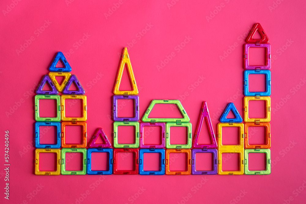 Obraz premium Model of the city from a magnetic constructor on a pink background.
